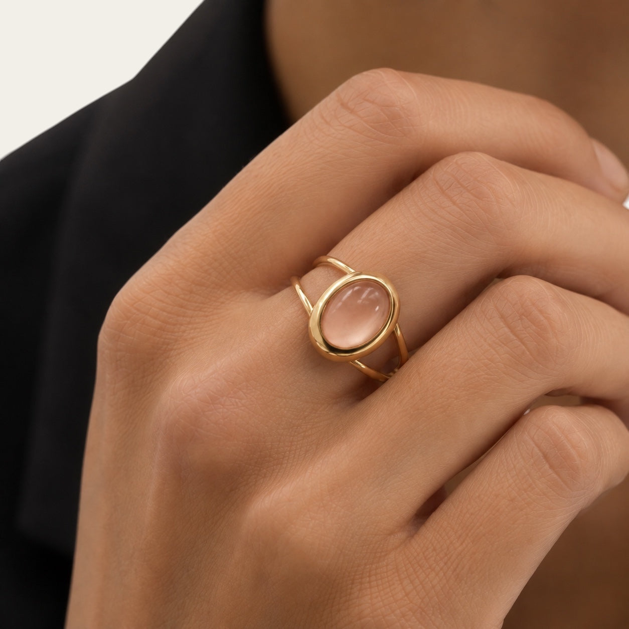Time4Me adjustable gold oval ring with a smooth pink stone worn on a finger
