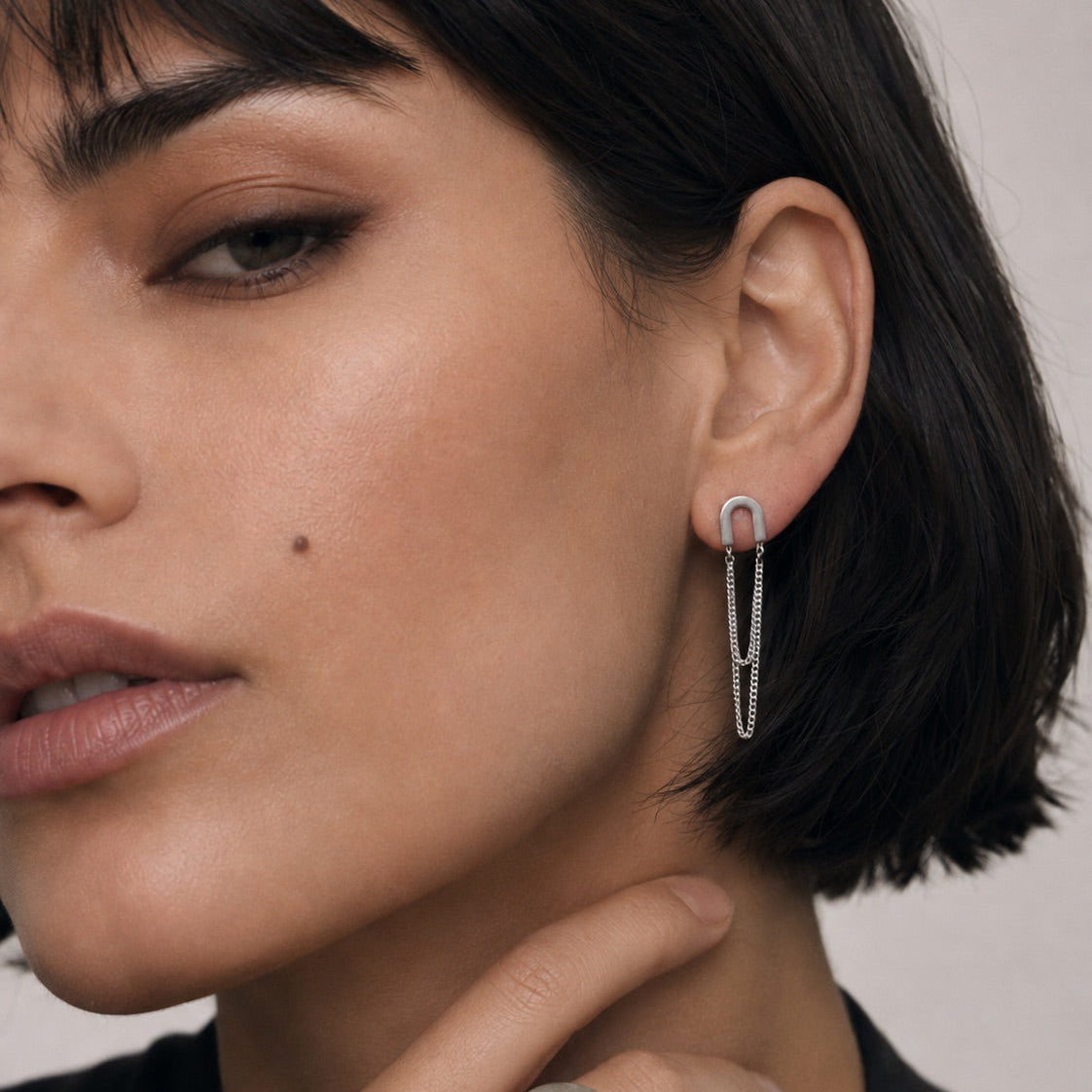 Time4Me silver U-shaped earrings with double hanging chains worn by a woman, made of durable stainless steel.