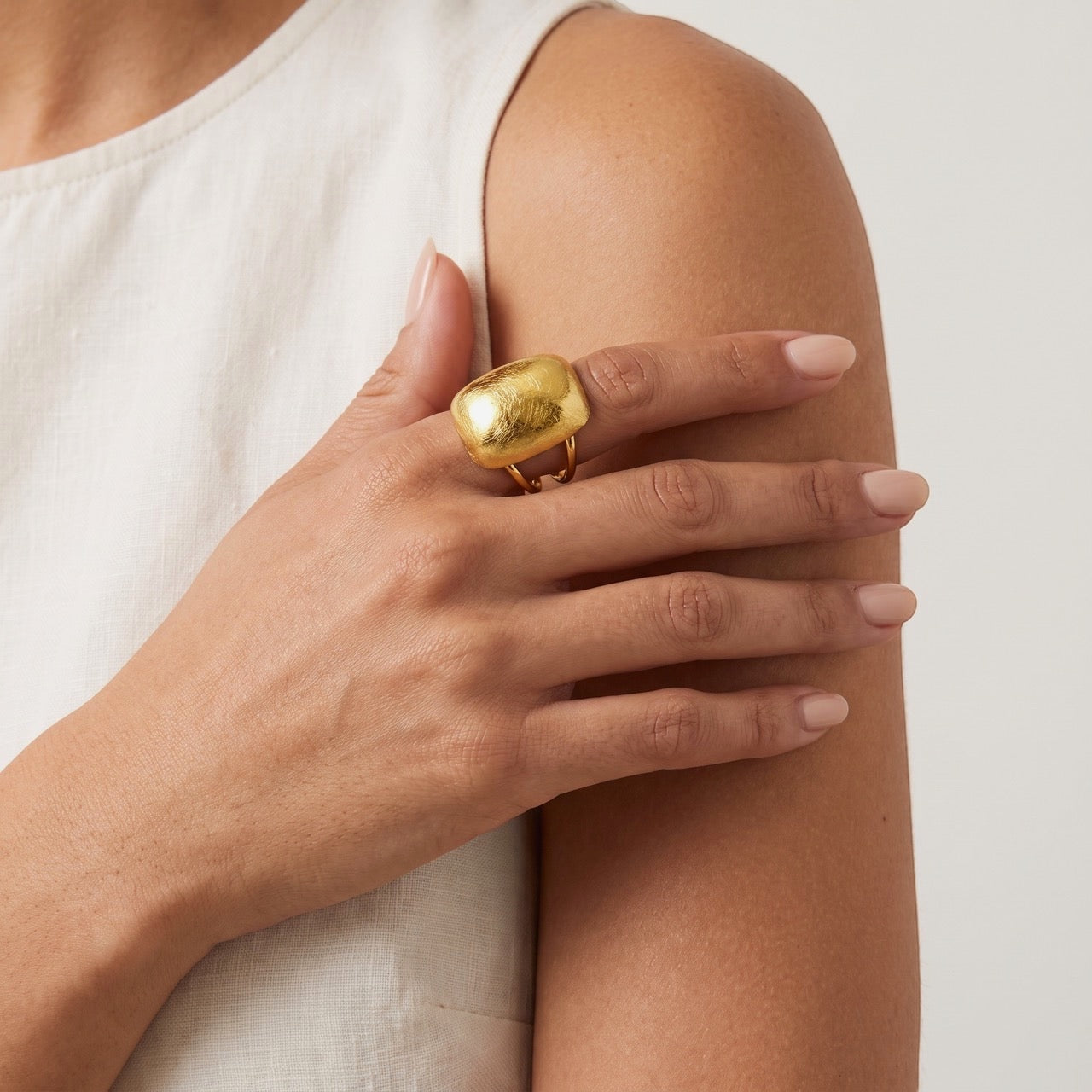 Time4Me adjustable gold-toned stainless steel ring with a brushed domed surface worn on a woman's finger