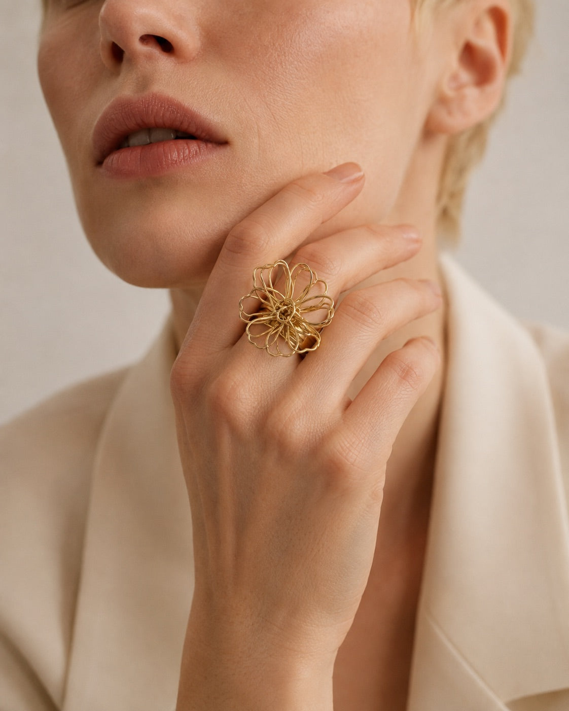 Time4Me adjustable gold stainless steel ring with a delicate lace-like flower motif worn on a woman's hand
