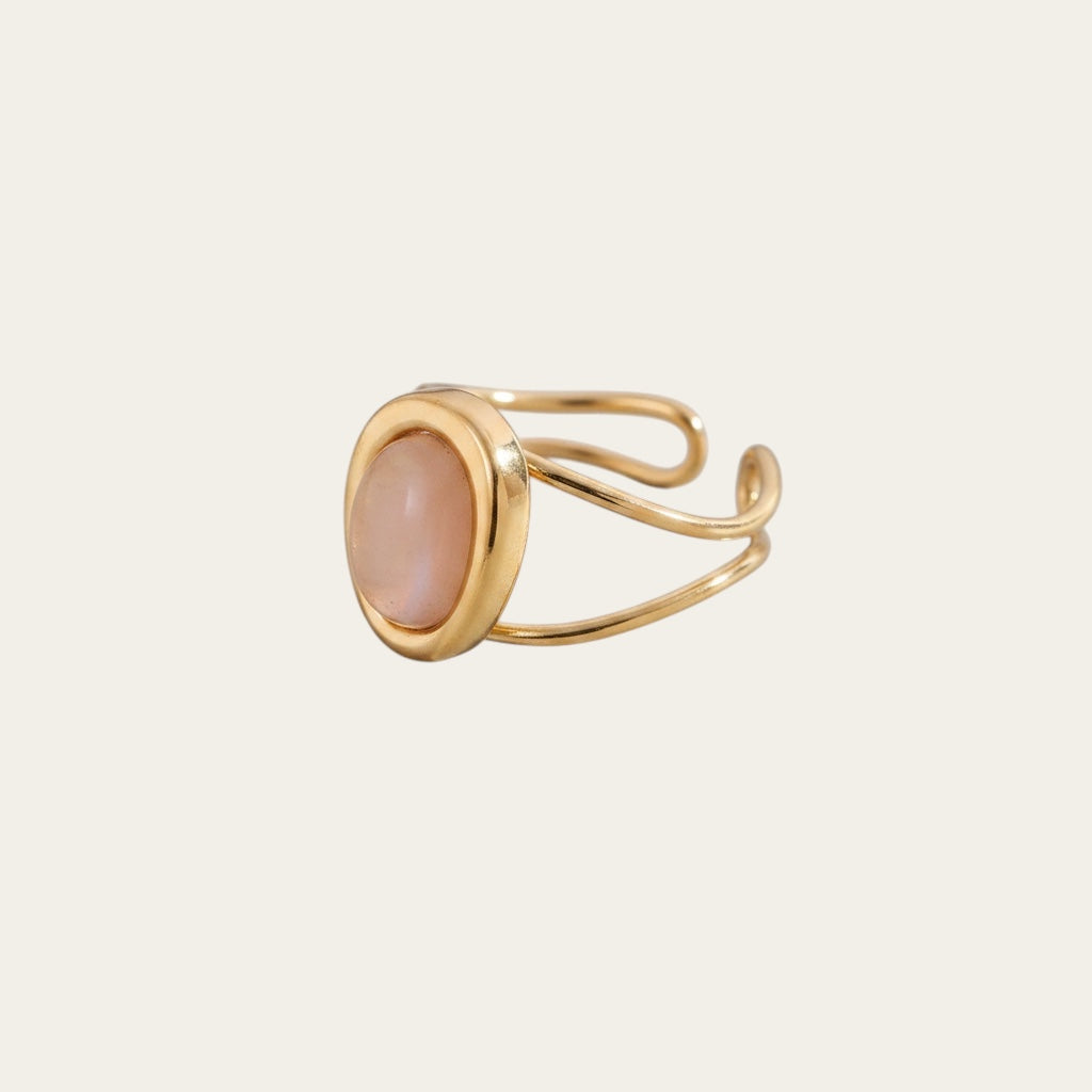Time4Me adjustable gold-tone stainless steel ring featuring a smooth oval pink stone center