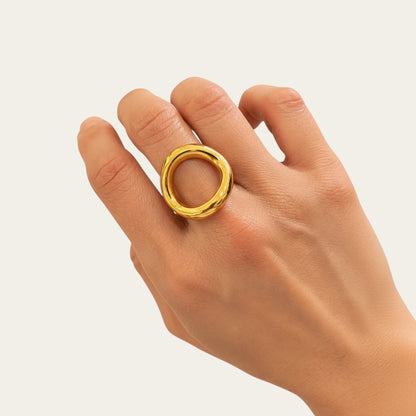 Time4Me adjustable gold-tone oval ring with a polished finish worn on a woman's finger against a neutral background
