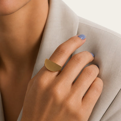 Time4Me adjustable gold ring featuring a thick semi-disc design worn on a finger against a neutral blazer background