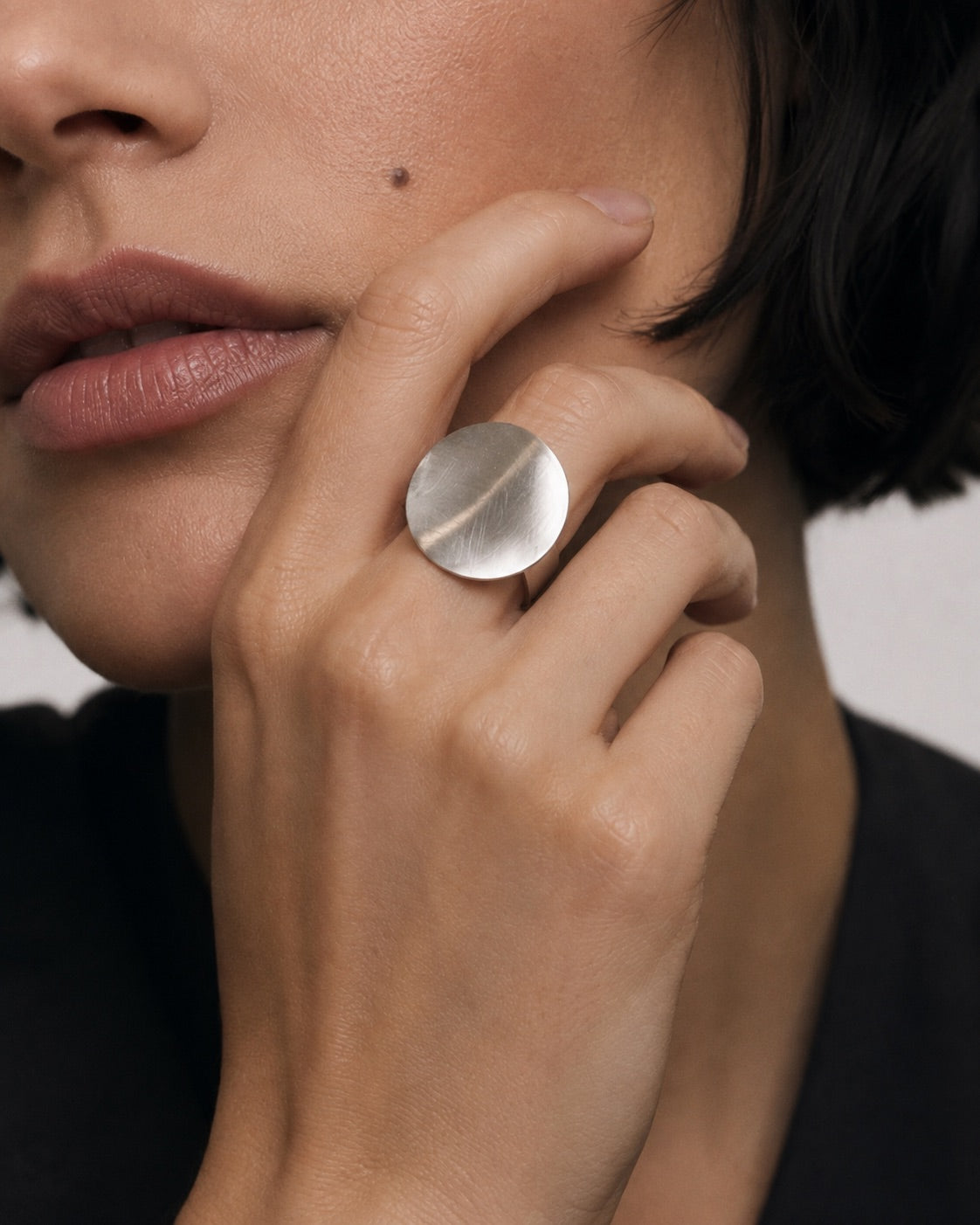 Time4Me adjustable silver stainless steel ring featuring a minimalist brushed circular disc worn on a woman's finger