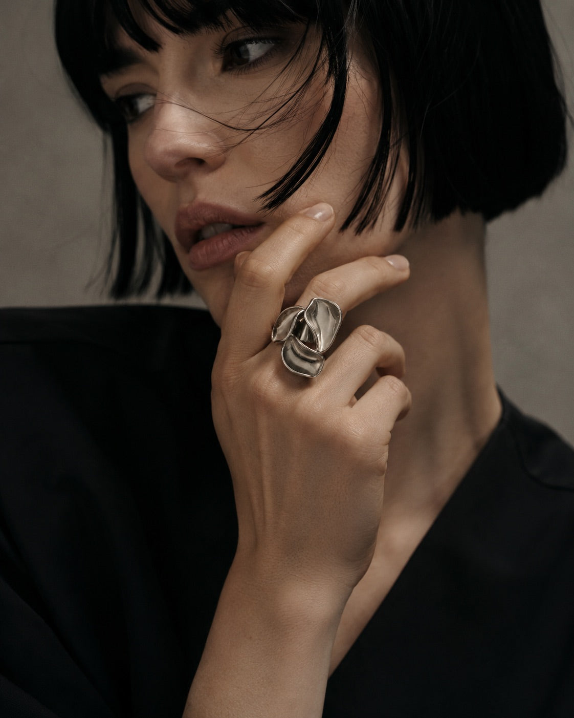 Time4Me adjustable silver-tone stainless steel ring featuring a sculptural three-petal floral design on a model