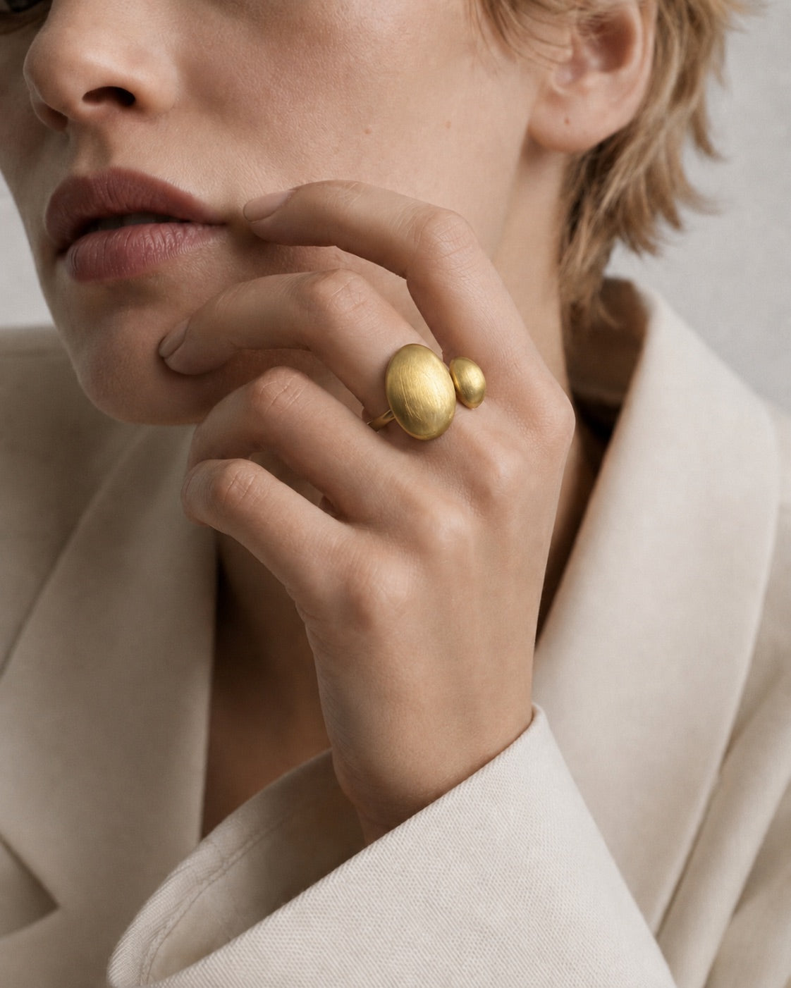 Time4Me gold-tone adjustable ring with asymmetric brushed-finish domed shapes worn on a woman's finger