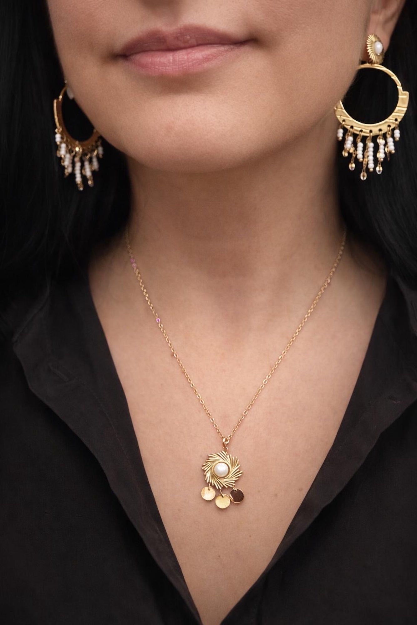 Time4Me gold boho earrings with white beaded fringe and matching sunburst pendant necklace on a woman