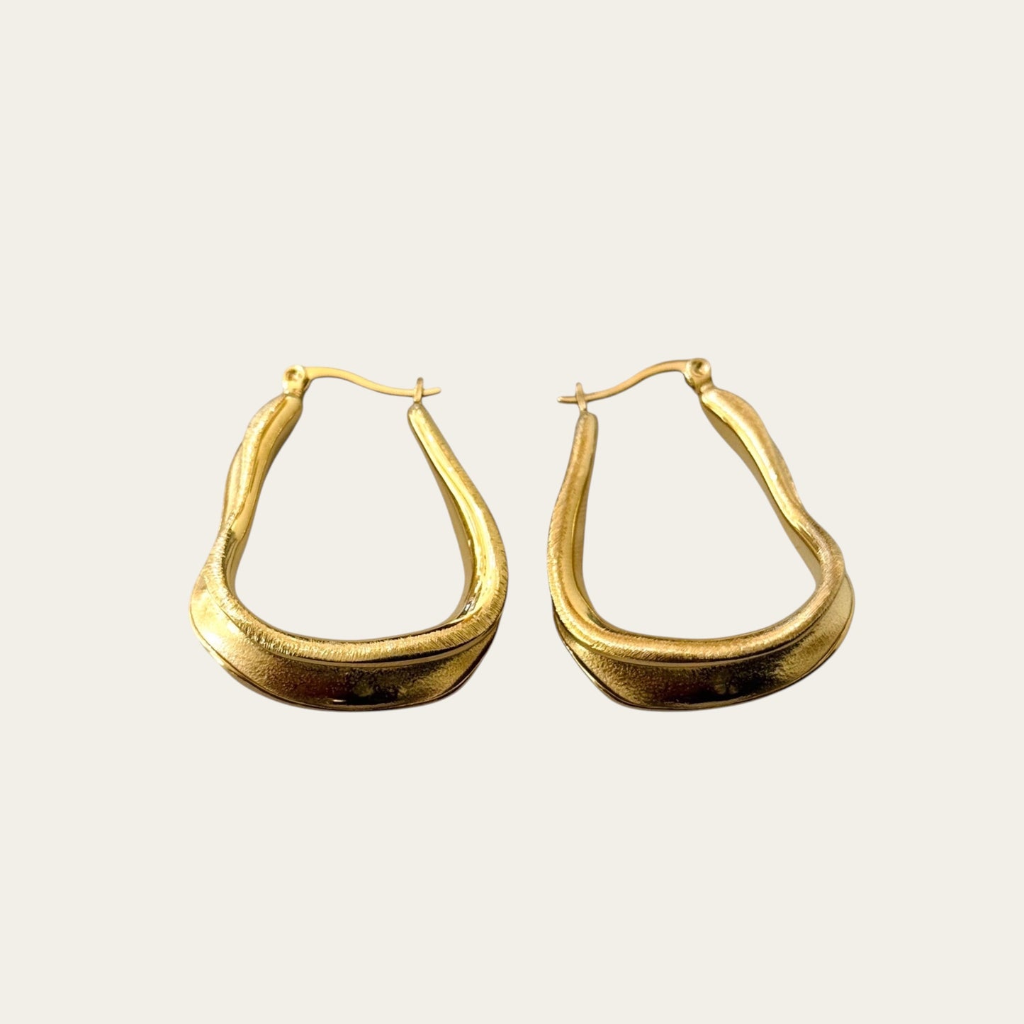 Time4Me brushed gold-tone stainless steel hoop earrings with a unique organic shape for a versatile elegant look.