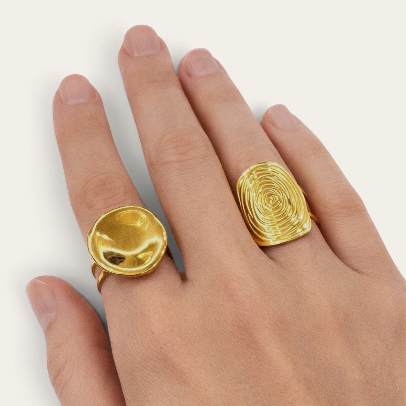 Time4Me gold-toned button-style ring and textured oval ring worn on a hand for a stylish layered look.