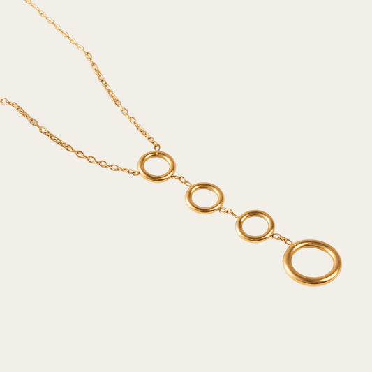 Time4Me gold-tone stainless steel necklace featuring four vertically aligned circular pendants on a delicate chain