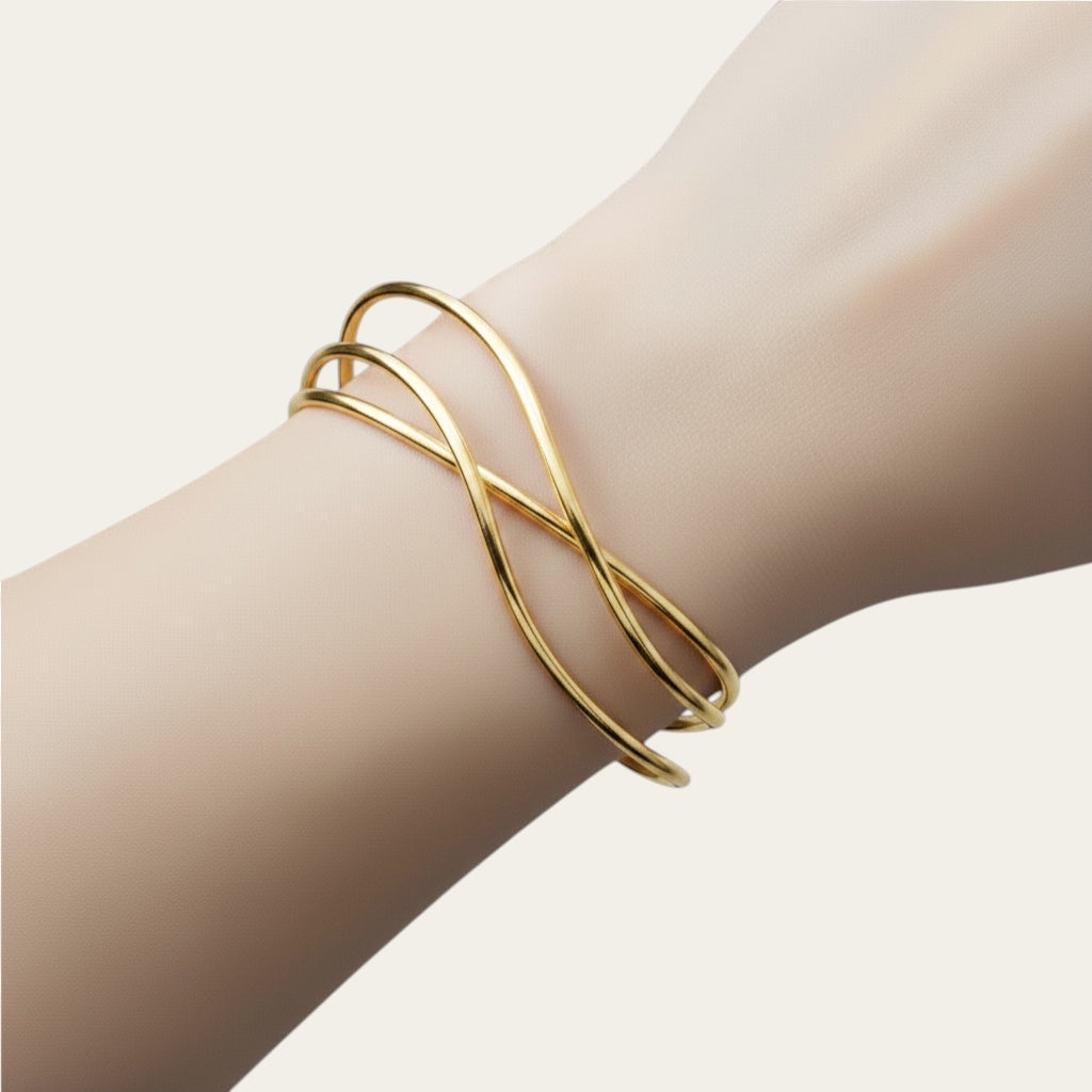 Time4Me gold-tone stainless steel open cuff bracelet with a delicate crisscross design worn on a wrist