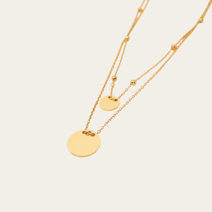 Time4Me gold-tone stainless steel double-chain necklace with two round disc pendants for a layered look.