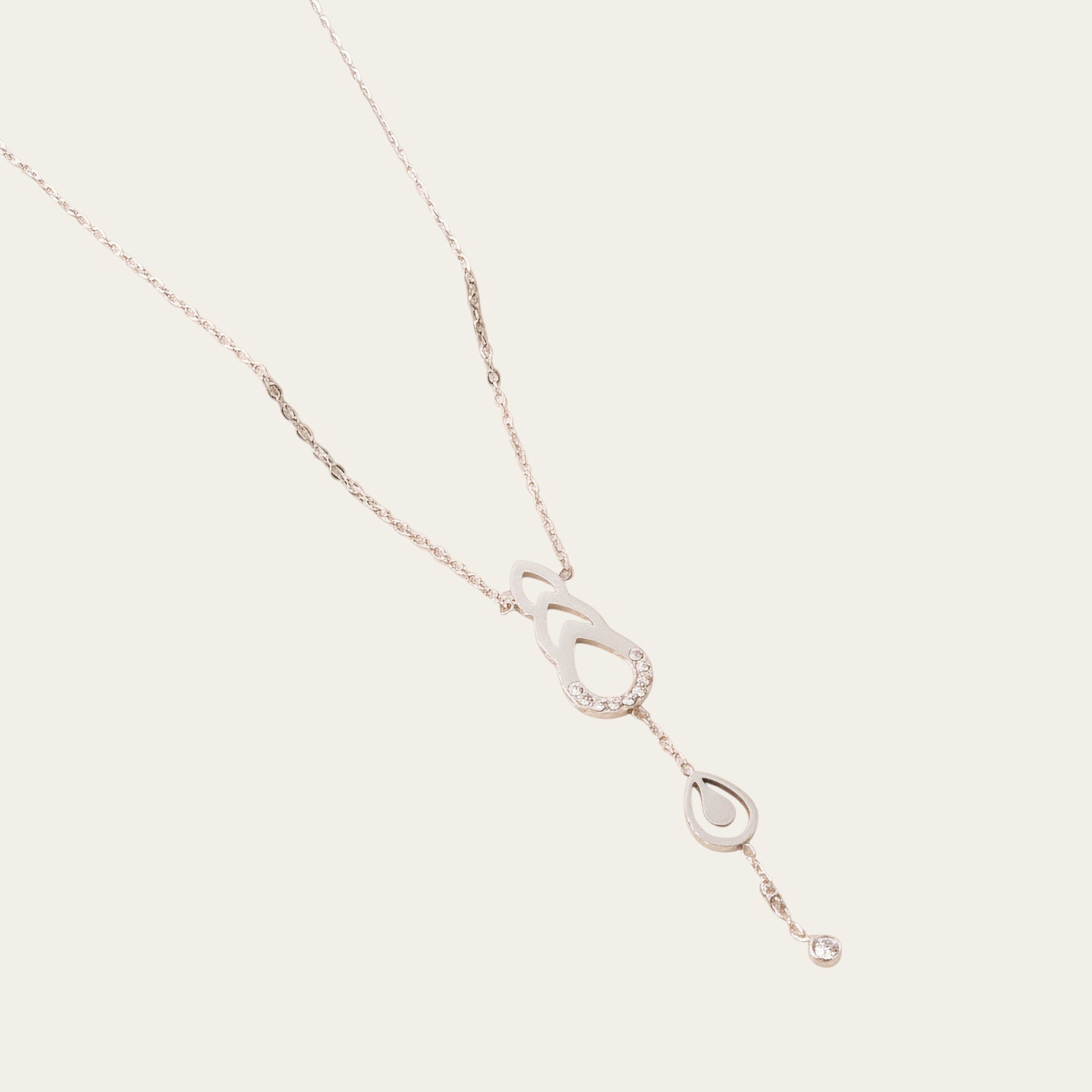 Time4Me gold-tone stainless steel necklace featuring delicate drop-shaped cutouts and sparkling rhinestone accents.