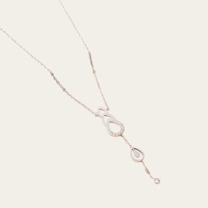 Time4Me gold-tone stainless steel necklace featuring delicate drop-shaped cutouts and sparkling rhinestone accents.
