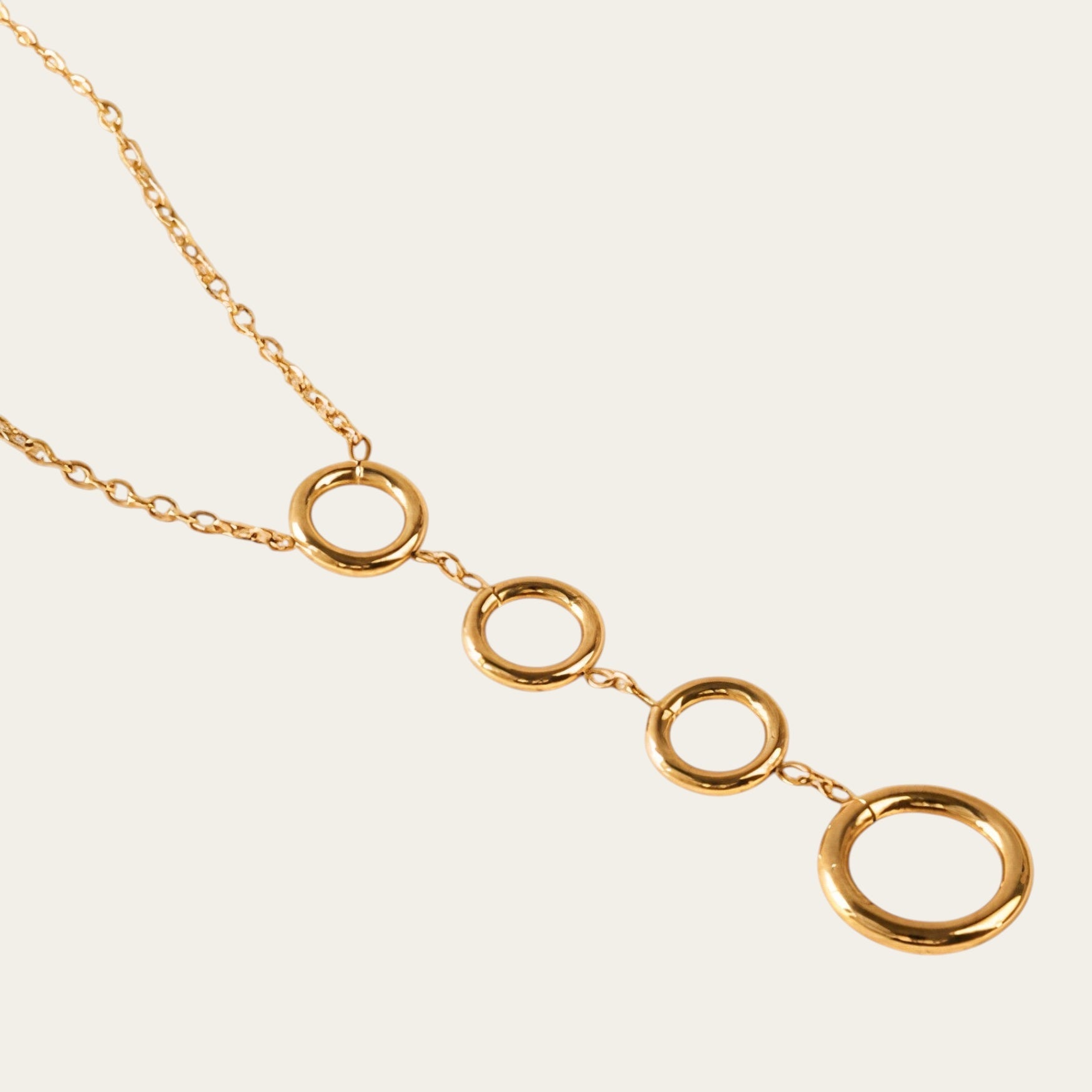 Time4Me gold-tone stainless steel necklace featuring four vertically aligned circular pendants on a delicate chain.