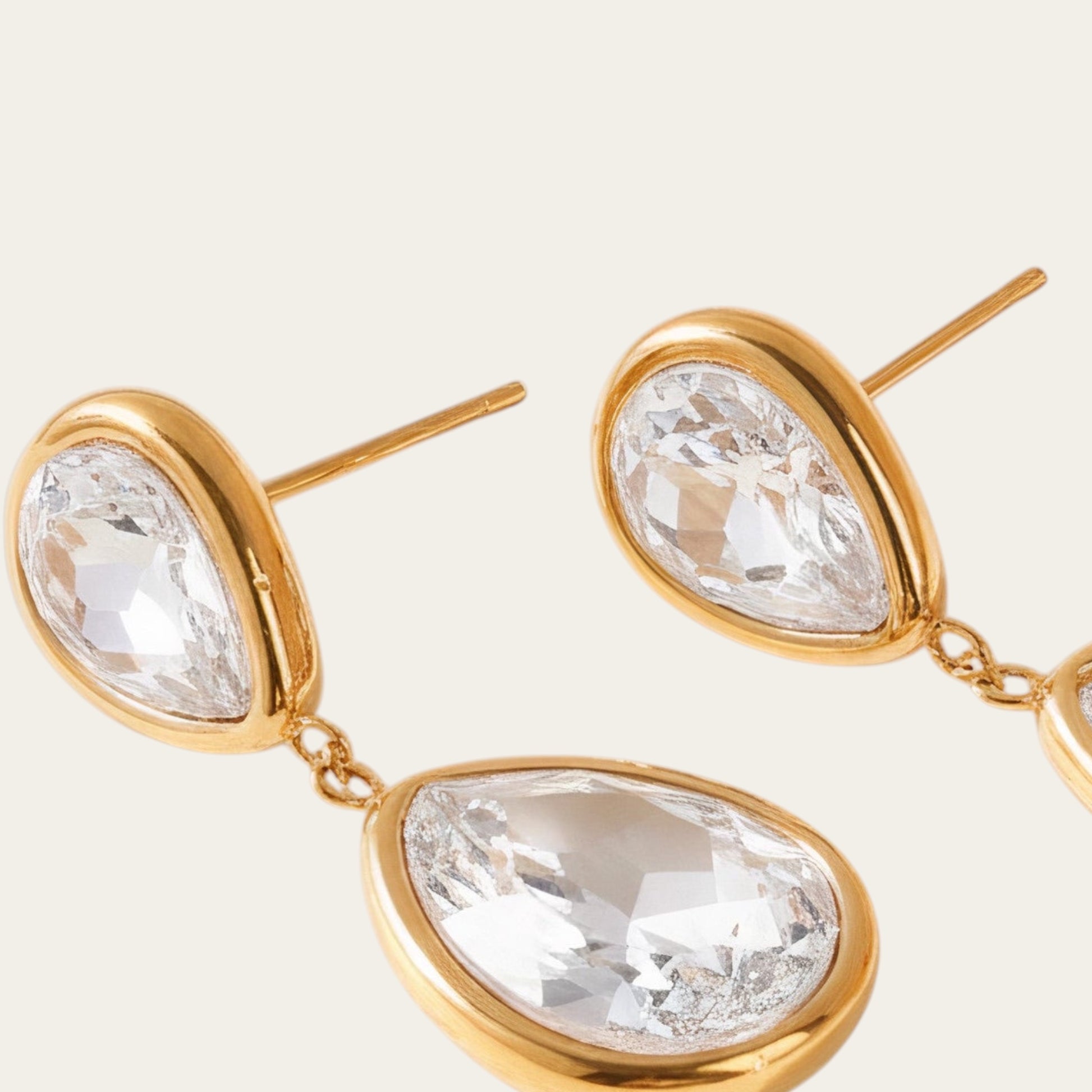 Time4Me long gold-tone stainless steel earrings featuring two clear glass teardrop pendants in a delicate design