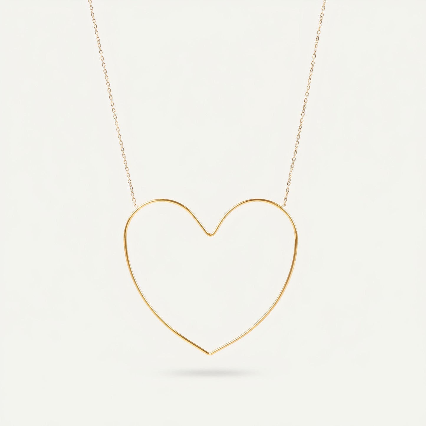 Time4Me gold-tone stainless steel necklace featuring a minimalist stylized open heart pendant on a delicate chain.