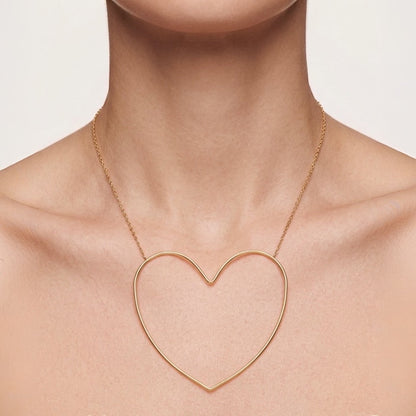 Time4Me gold-toned stainless steel necklace featuring a large minimalist stylized heart pendant on a delicate chain.