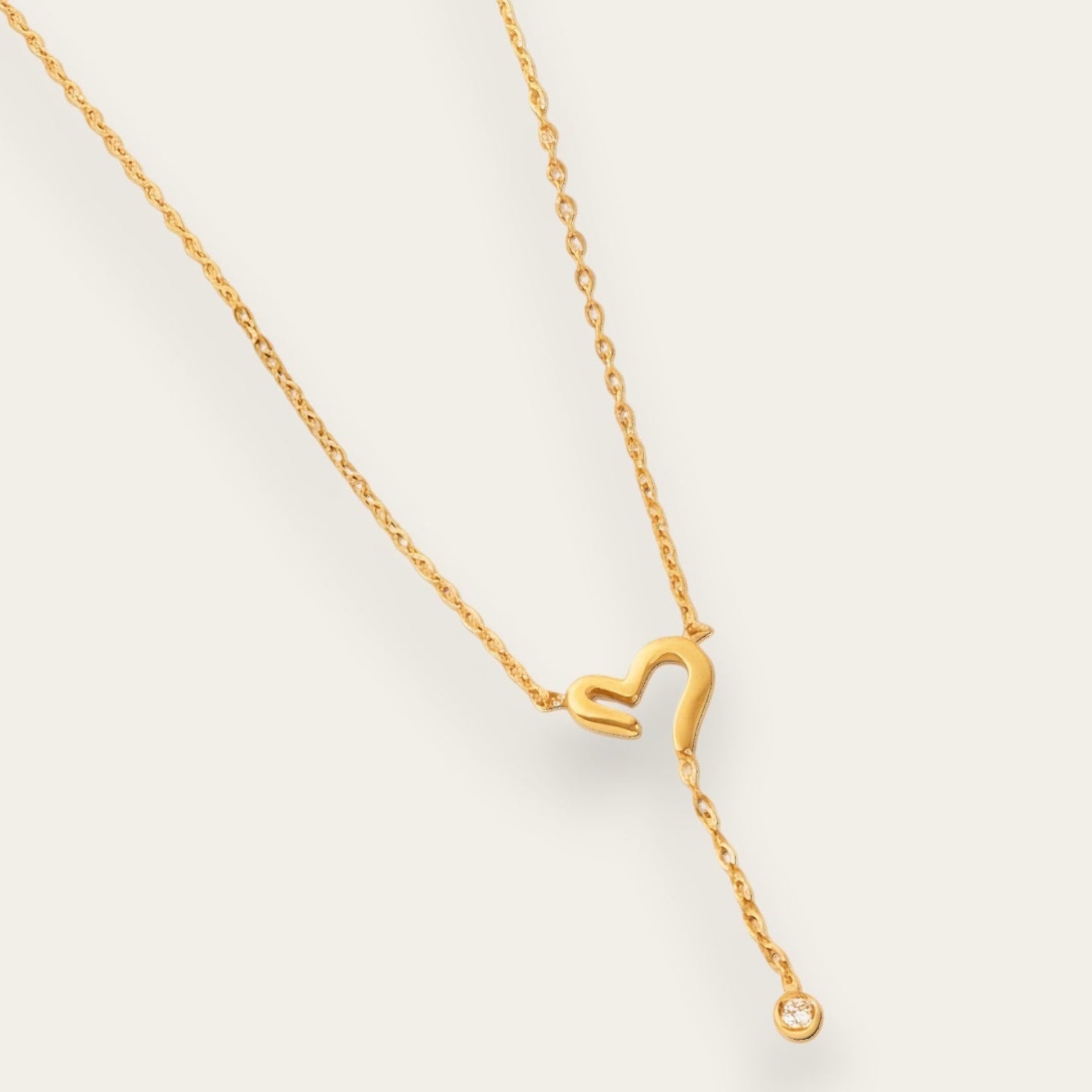 Time4Me gold stainless steel necklace featuring a cutout heart pendant and a delicate dangling crystal charm
