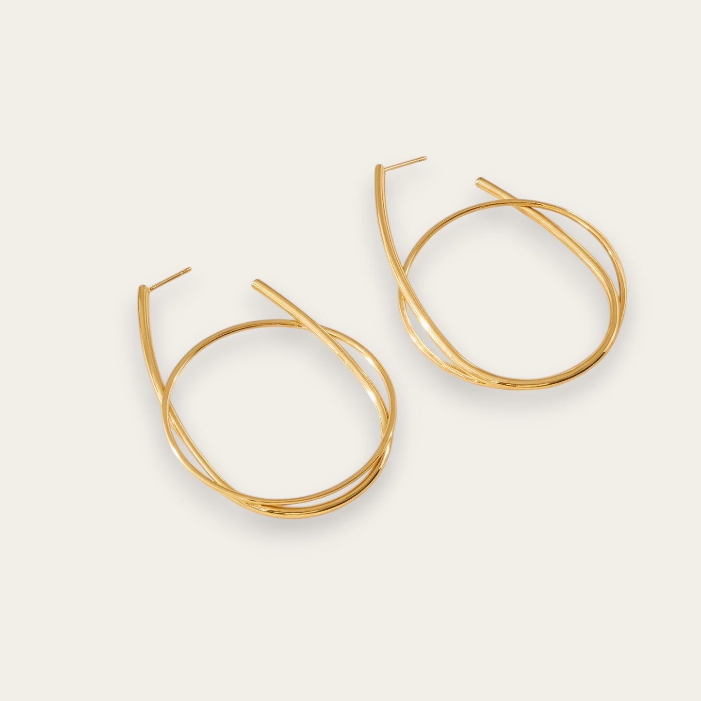 Time4Me gold-tone hoop earrings featuring a stylish intertwined ring design made from durable stainless steel