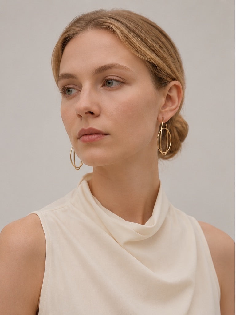 Time4Me gold hoop earrings with intertwined ring design worn by a woman with a sleek bun hairstyle