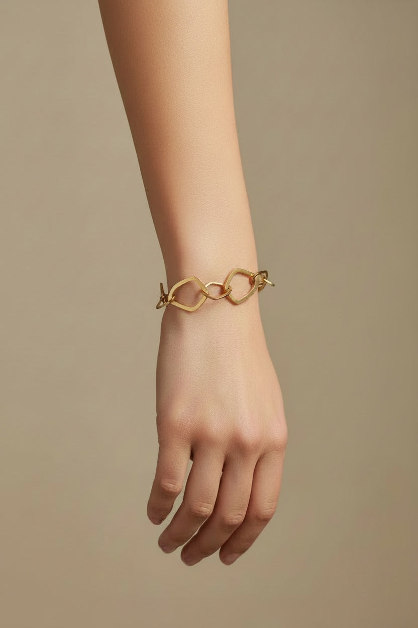 Time4Me gold-tone stainless steel bracelet featuring irregular geometric chain links worn on a woman's wrist.