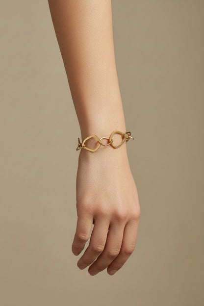 Time4Me gold-tone stainless steel bracelet featuring irregular geometric chain links worn on a woman's wrist.