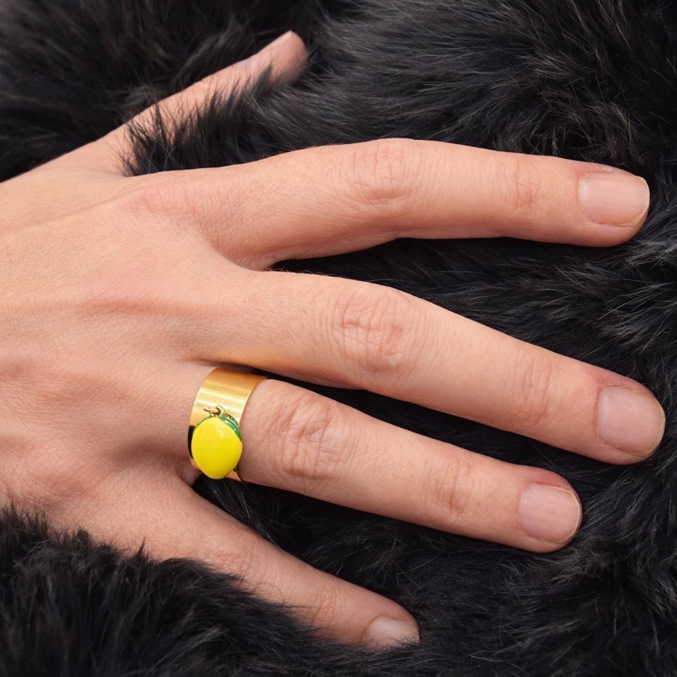 Time4Me adjustable gold stainless steel ring featuring a bright yellow lemon charm on a black faux fur background