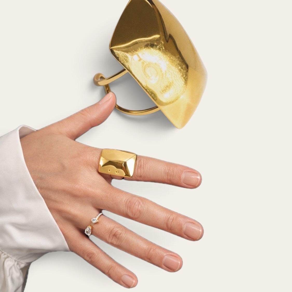 Time4Me gold-toned adjustable ring with a unique melted metal effect worn on a hand with a delicate crystal ring