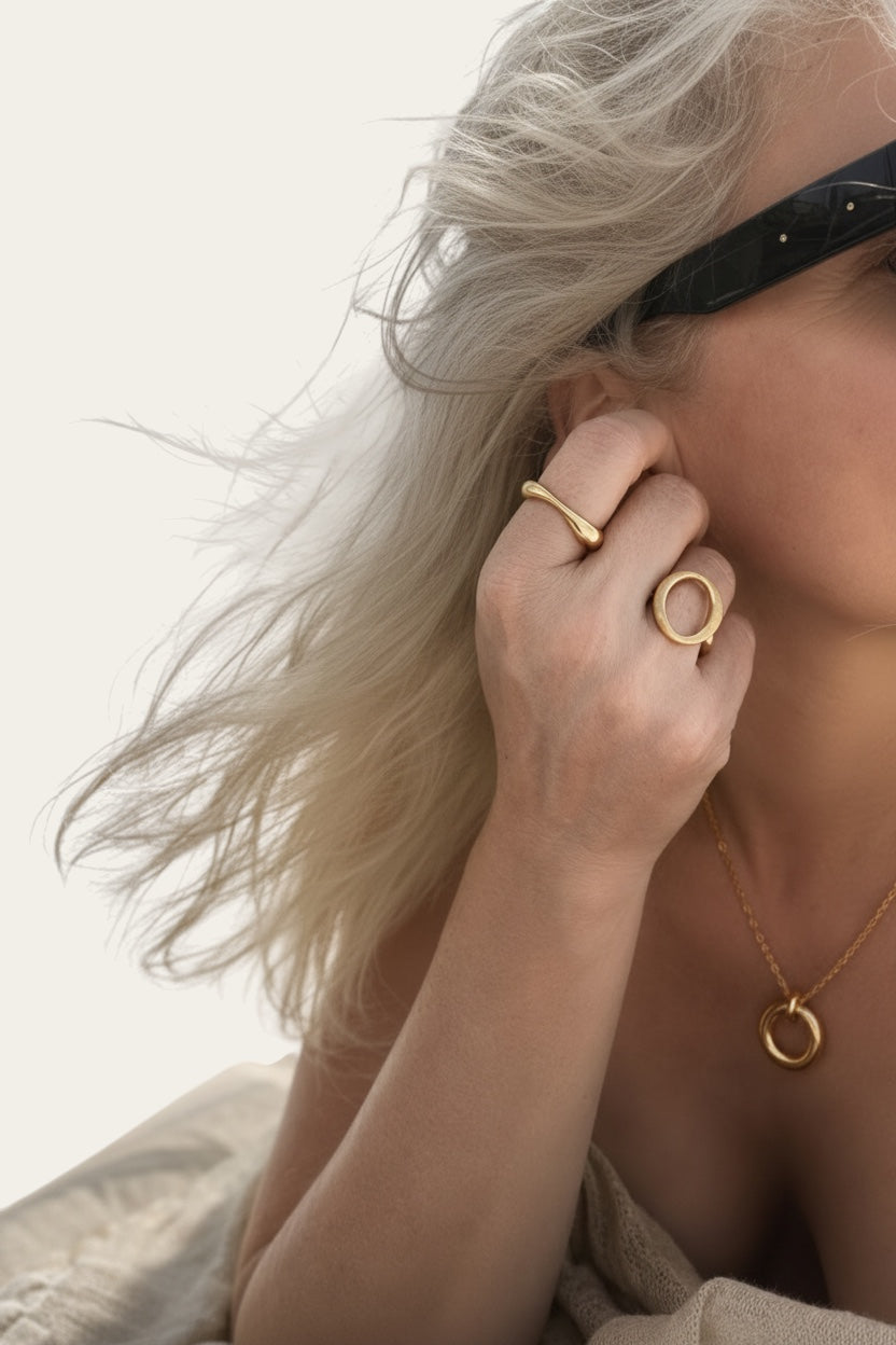Time4Me gold adjustable organic shaped ring worn on a woman's hand with a matching necklace