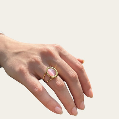 Time4Me adjustable gold stainless steel ring featuring a pink oval stone worn on a woman's finger
