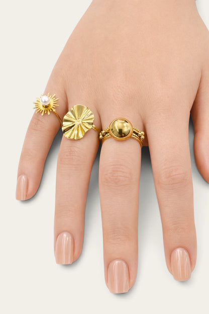 Time4Me gold oval wave ring worn on a hand alongside other gold rings with pearl and spherical accents