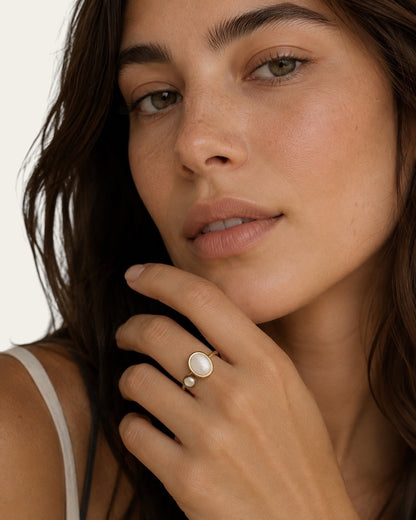 Time4Me adjustable gold stainless steel ring featuring a white pearl and mother of pearl accent on a woman's hand