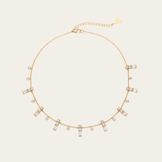 Time4Me gold chain necklace featuring delicate dangling baguette and round rhinestone charms in stainless steel.