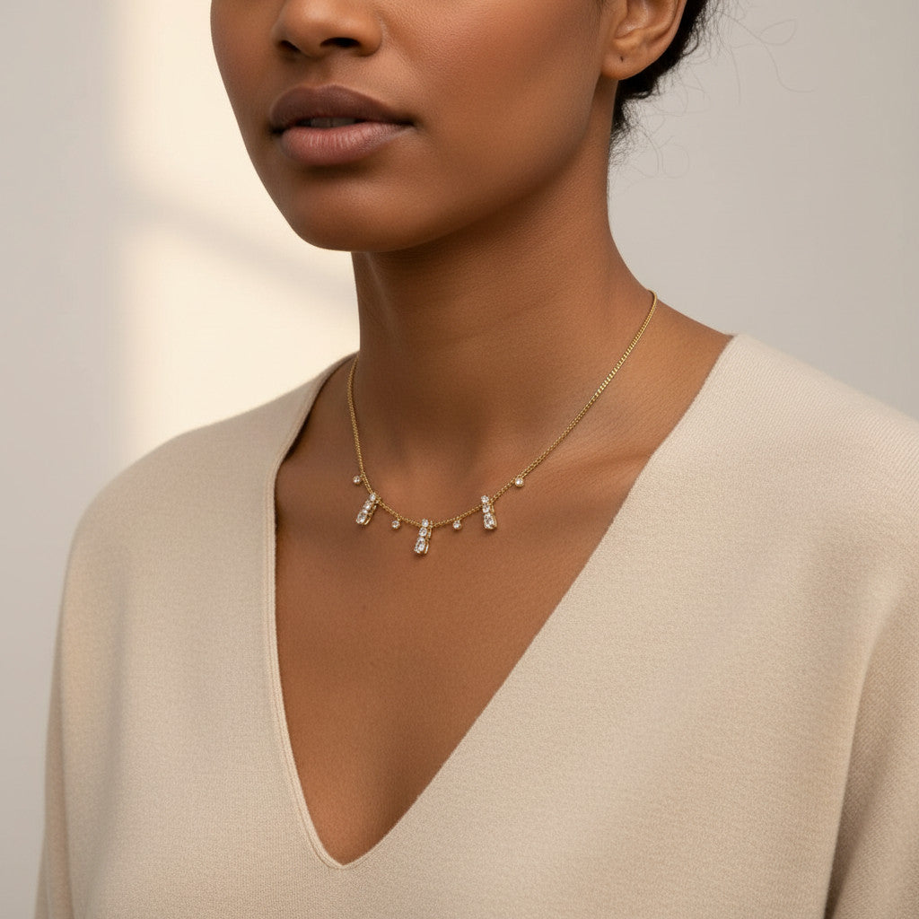 Time4Me gold chain necklace featuring delicate dangling rhinestone pendants worn by a model in a beige top