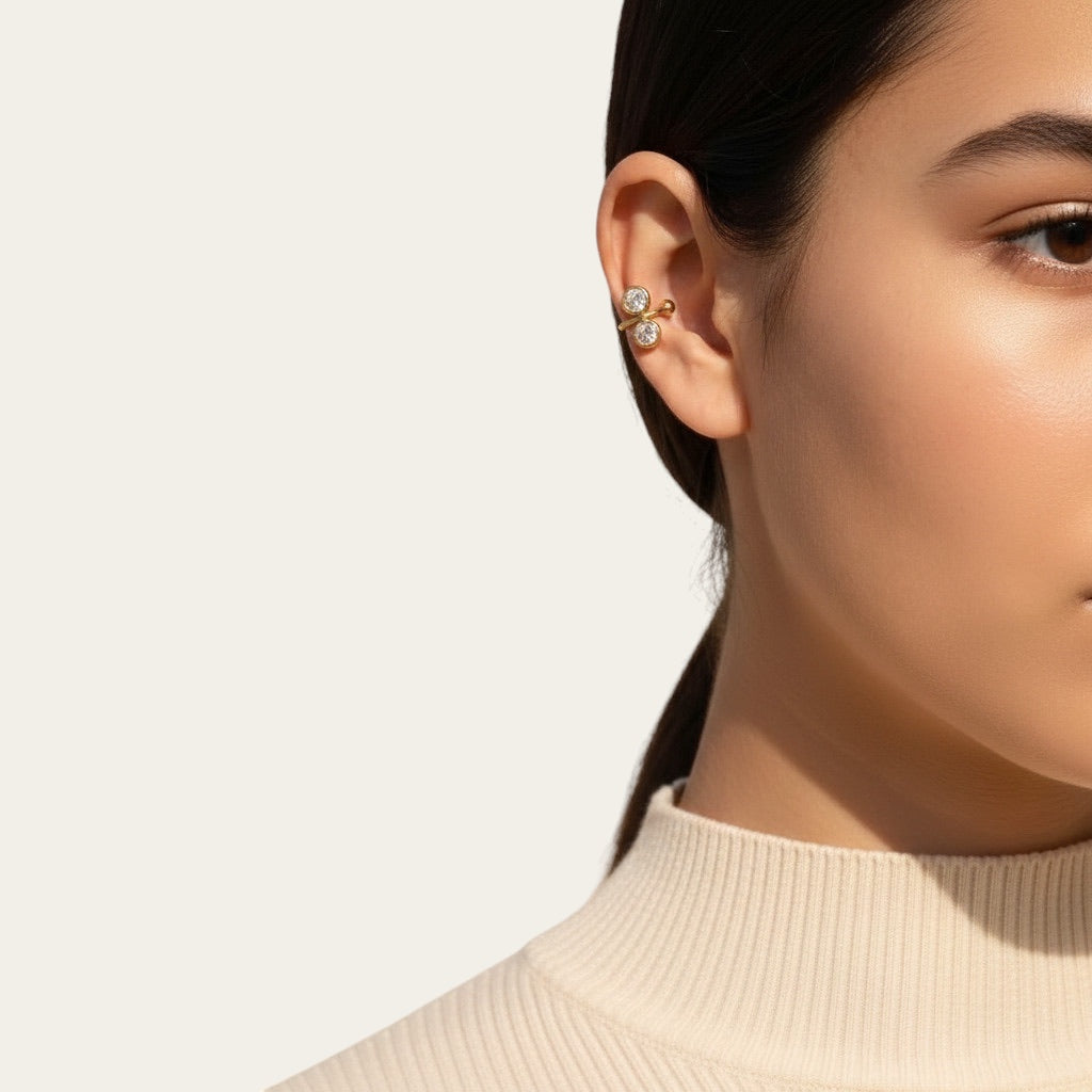 Time4Me gold stainless steel ear cuff featuring two round sparkling rhinestones worn on a model's ear