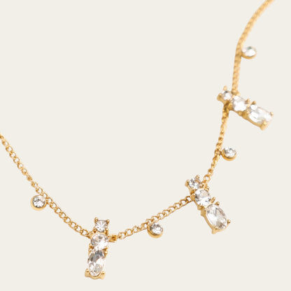 Time4Me gold-tone stainless steel necklace featuring delicate chain with dangling clear rhinestone pendants