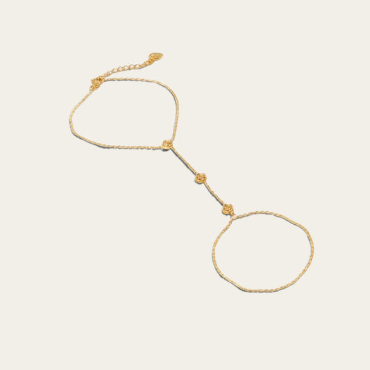 Time4Me gold-tone slave bracelet featuring delicate chain links and small floral accents for a statement look.
