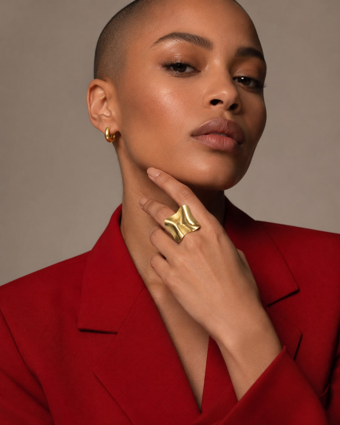 Time4Me gold square ring with a crinkled texture worn by a model in a red blazer