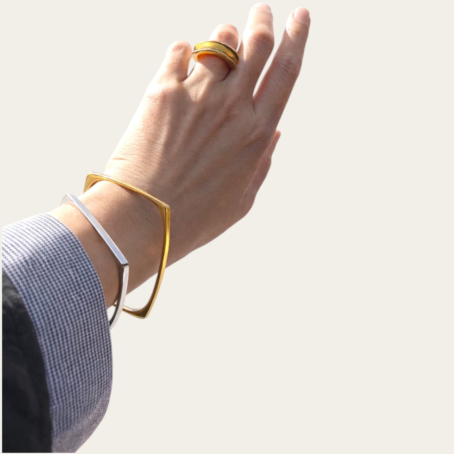 Time4Me gold square stainless steel bracelet worn on a wrist alongside a silver bracelet and a gold ring
