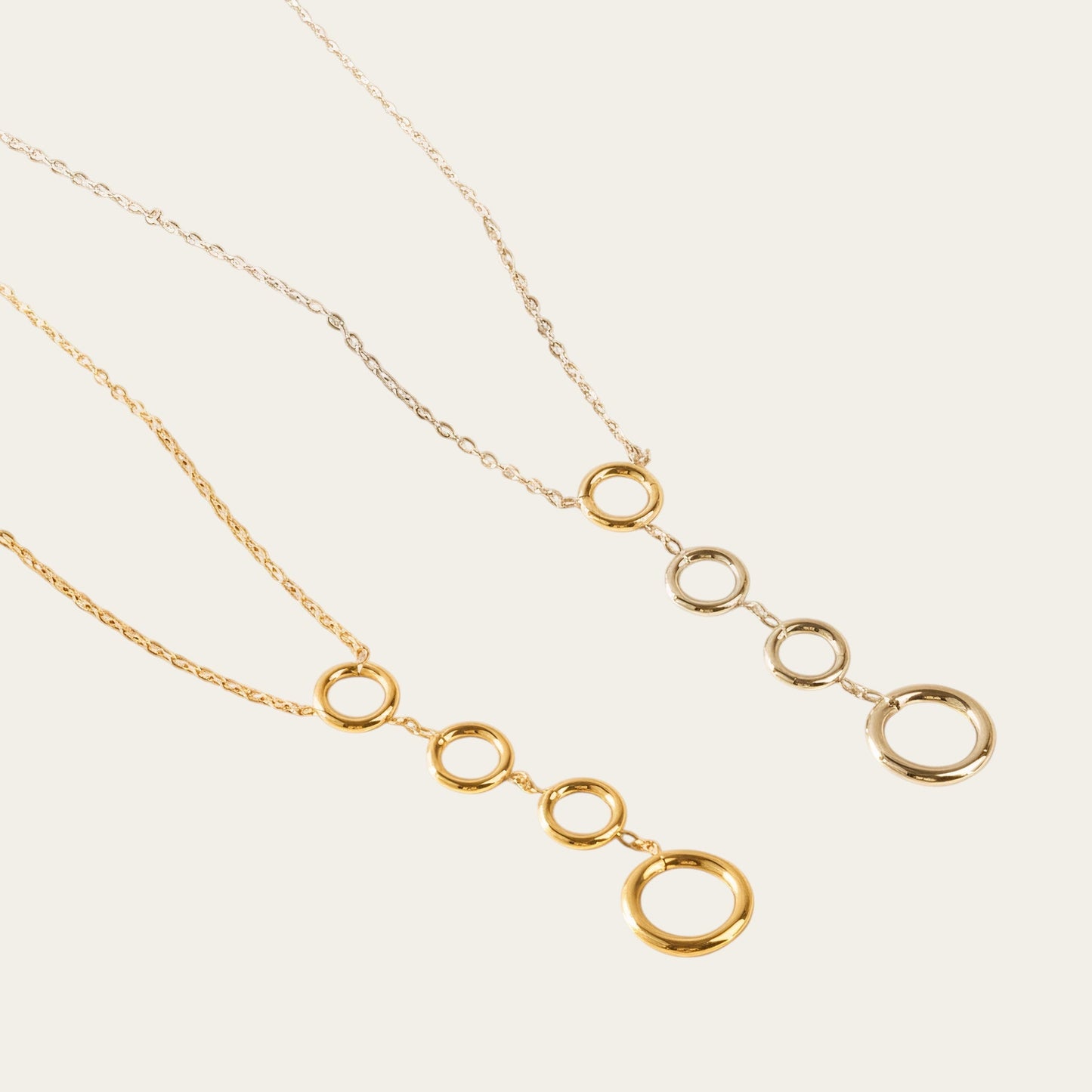 Time4Me gold-tone stainless steel necklace featuring four vertically aligned circular pendants on a delicate chain