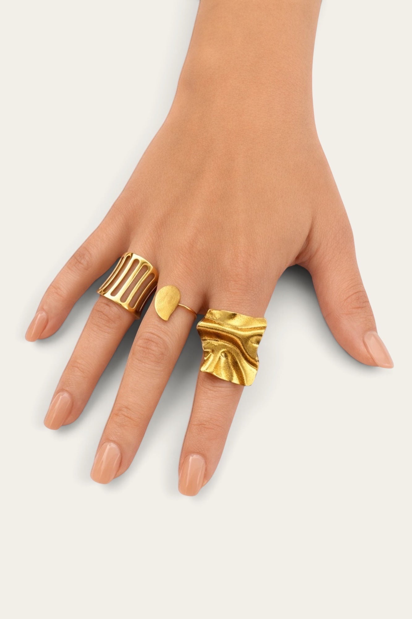 Time4Me gold teardrop ring worn on a hand alongside other stylish gold-tone stainless steel rings
