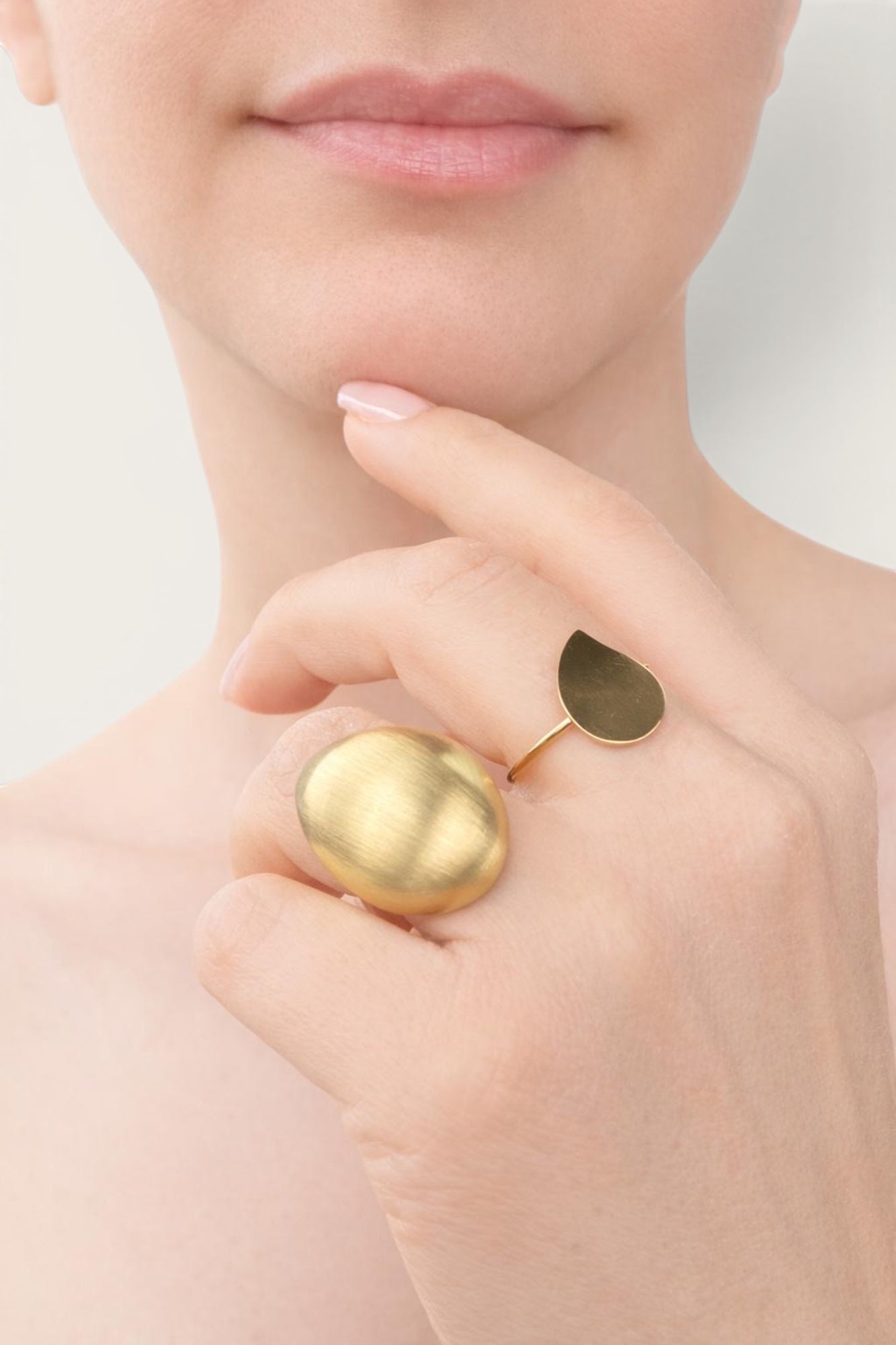 Time4Me gold teardrop ring worn on a finger with a brushed finish, made of durable stainless steel.