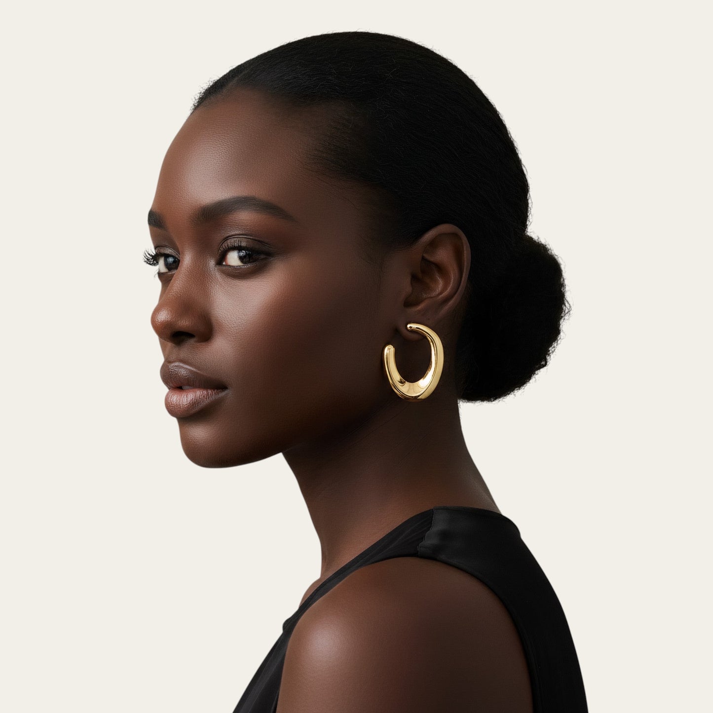 Time4Me gold open hoop earrings worn by a woman with a sleek bun, featuring a thick, polished stainless steel design.
