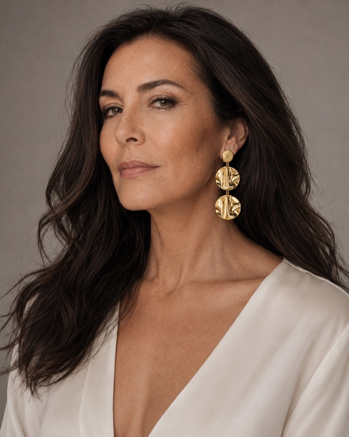 Time4Me gold drop earrings featuring three textured wavy discs worn by a woman in a white blouse