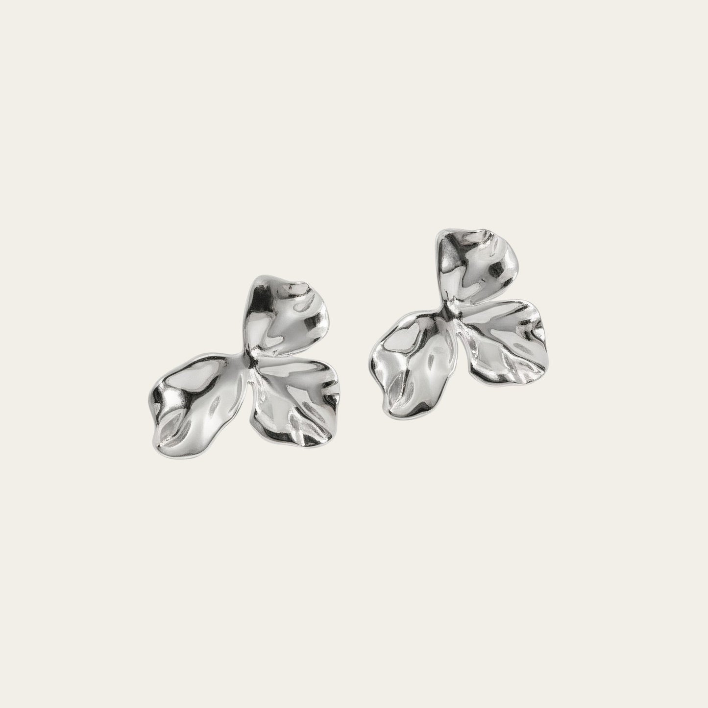 Time4Me gold-tone stainless steel stud earrings featuring a delicate wavy petal design on a neutral background.