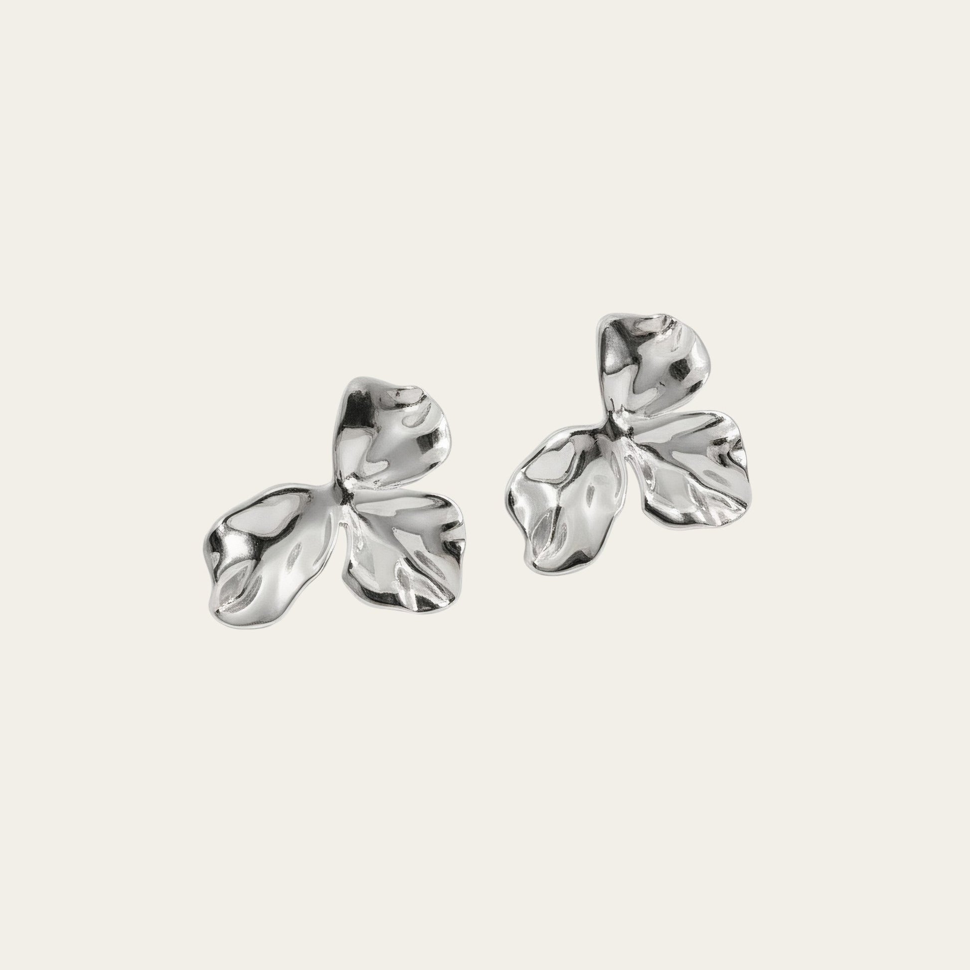 Time4Me gold-tone stainless steel stud earrings featuring a delicate wavy petal design on a neutral background.