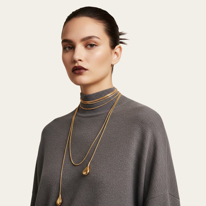 Time4Me long gold stainless steel chain necklace worn by a model in a grey sweater for a layered elegant look