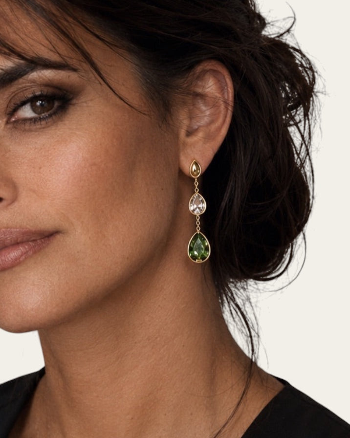 Time4Me long gold stainless steel earrings featuring white and green glass teardrop pendants on a woman