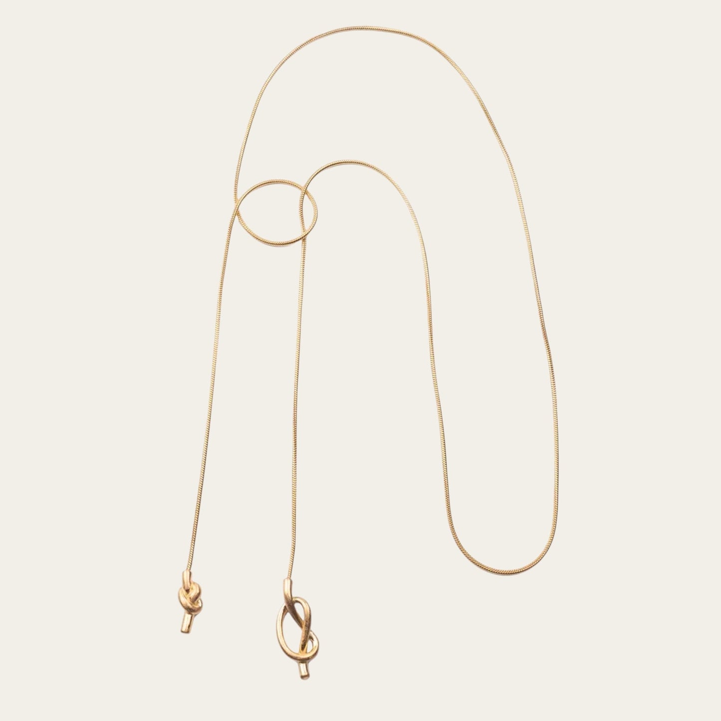 Time4Me 100cm long gold stainless steel necklace featuring an elegant asymmetrical knot design